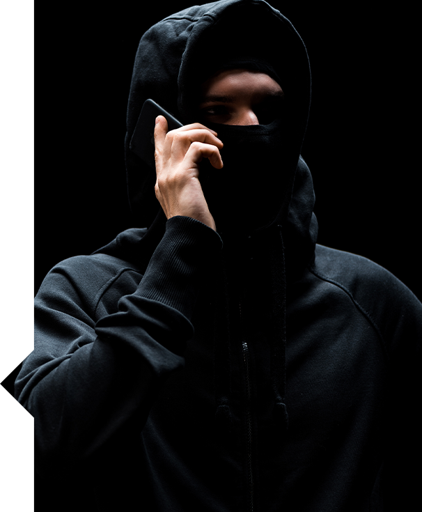 Hooded figure with hand near face